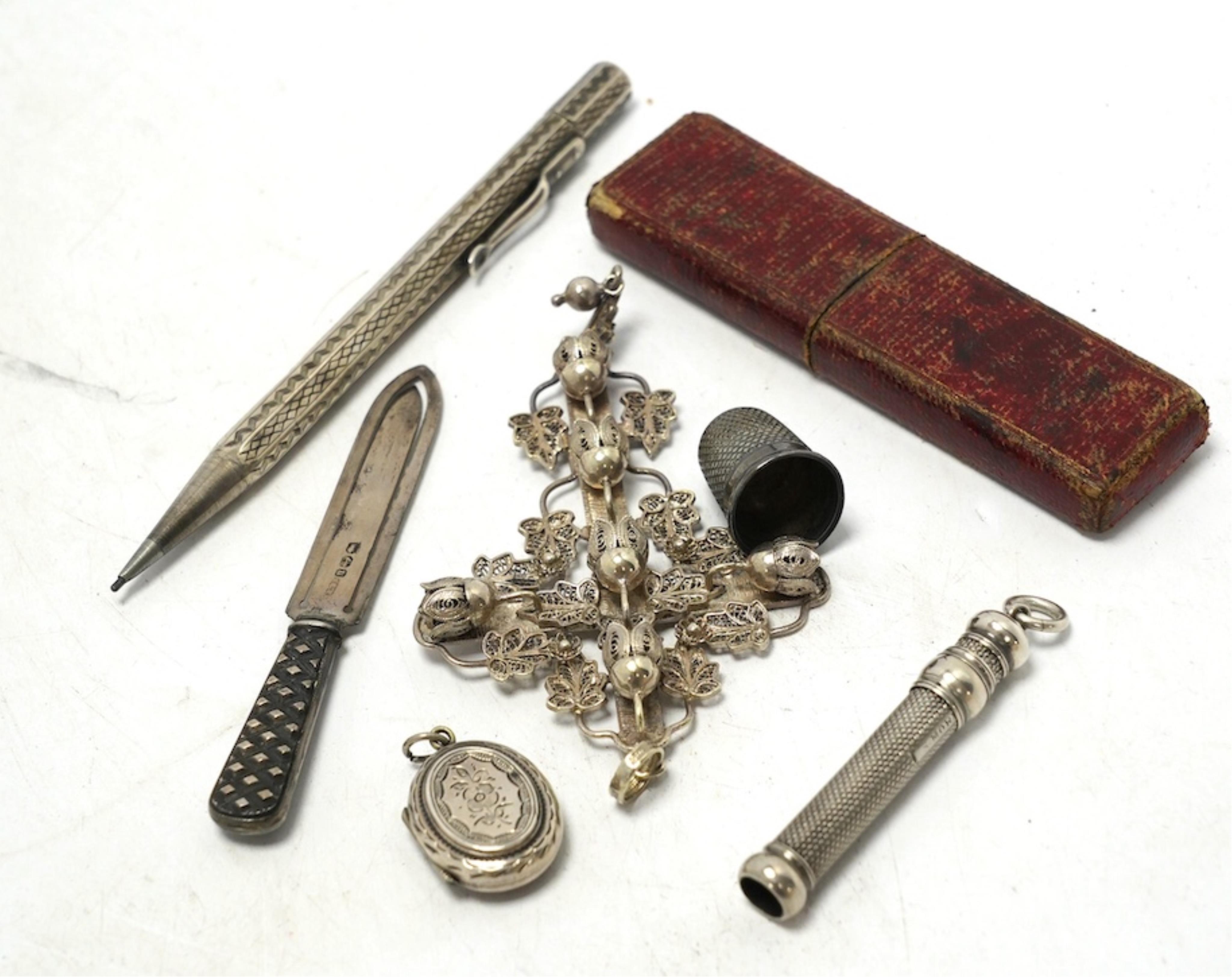 Small silver including a Victorian silver and mother of pearl fruit knife, a crucifix, a book mark, pencils, a thimble, etc. Condition - fair